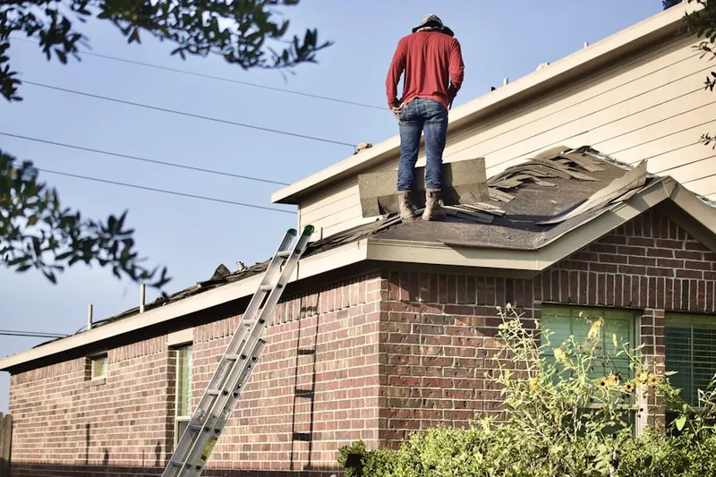 Professional roofer working on a residential roof in Peru